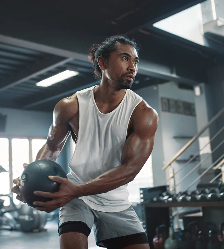 Man Building Muscle In Gym After Sermorelin