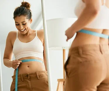 Person Measuring Weight Loss