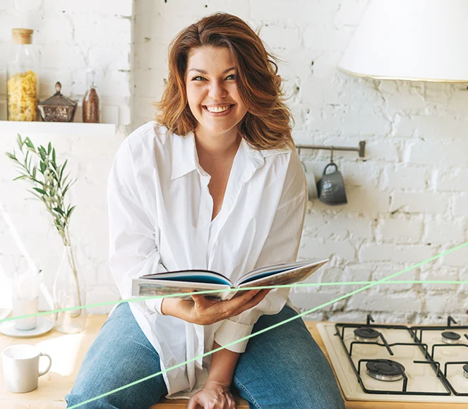 Woman Cooking With Weight Loss Book